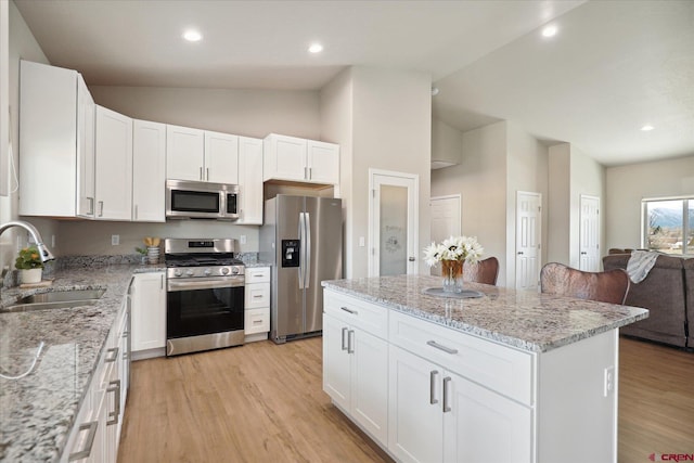 kitchen featuring light hardwood / wood-style flooring, white cabinets, appliances with stainless steel finishes, and sink