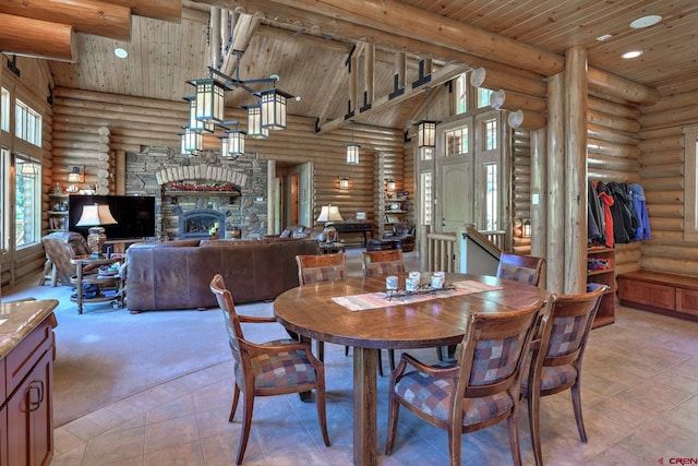 dining area featuring high vaulted ceiling, log walls, wooden ceiling, and a fireplace