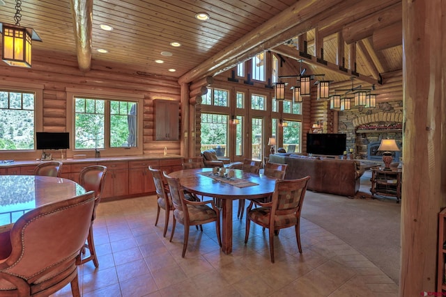 dining space featuring light tile floors, high vaulted ceiling, a fireplace, rustic walls, and wooden ceiling