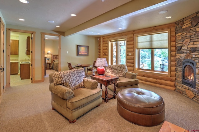 carpeted living room featuring rustic walls and a stone fireplace