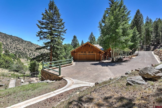 exterior space with a mountain view and a garage