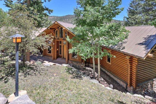 log home with a deck with mountain view