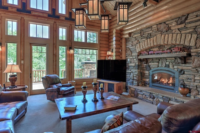 carpeted living room with rustic walls, a stone fireplace, and a high ceiling