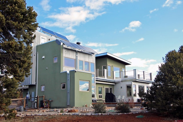 rear view of house with a balcony