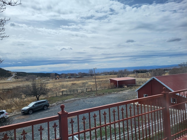 exterior space with a rural view and a mountain view