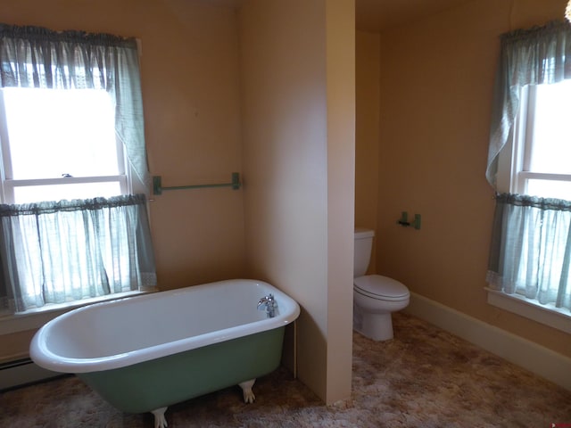 bathroom with toilet and a bath to relax in