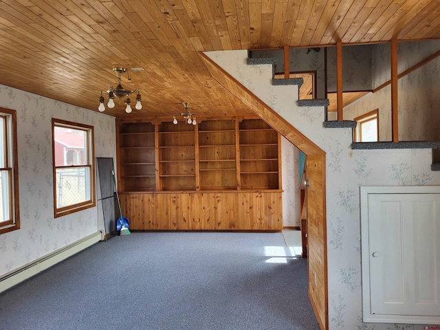 stairs featuring carpet floors, wooden ceiling, a baseboard radiator, and a chandelier