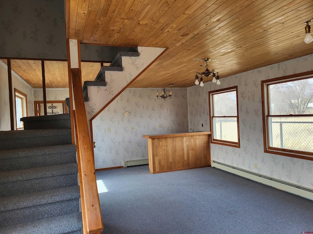 interior space with a notable chandelier, a baseboard heating unit, wood ceiling, and carpet