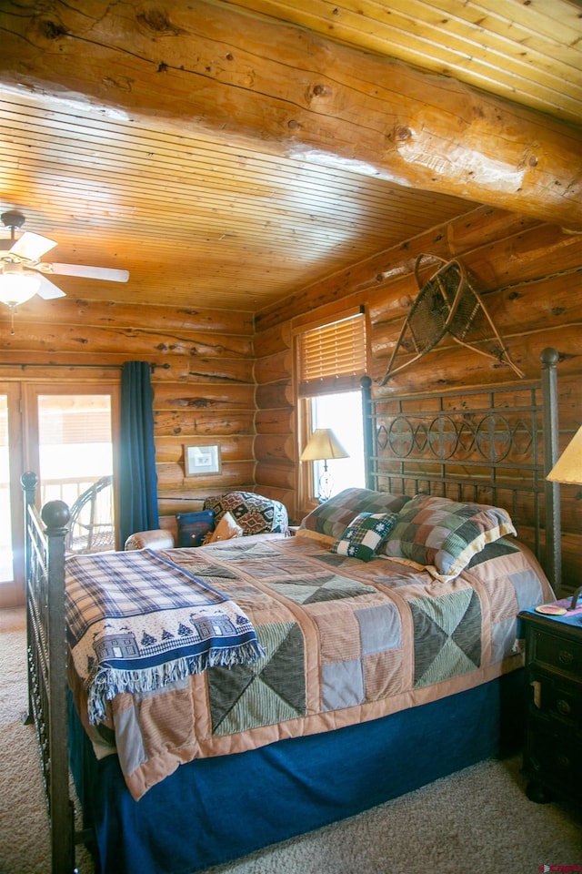 carpeted bedroom with log walls, ceiling fan, and wood ceiling