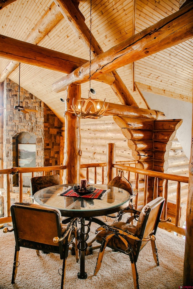 dining space featuring a notable chandelier, vaulted ceiling with beams, wood ceiling, and rustic walls