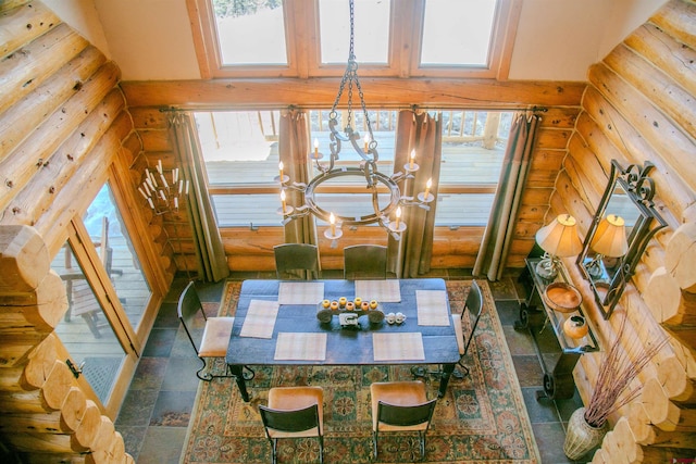 tiled dining space featuring an inviting chandelier, log walls, and a high ceiling