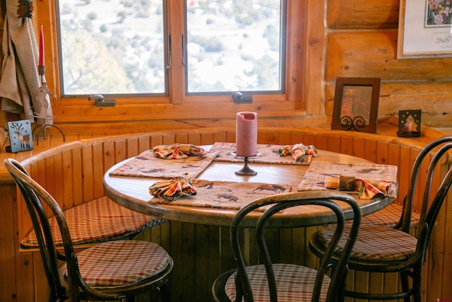 dining area with wood walls