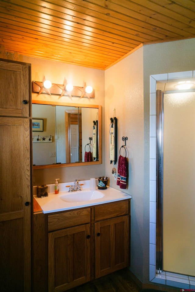 bathroom featuring vanity, a shower with shower door, and wood ceiling