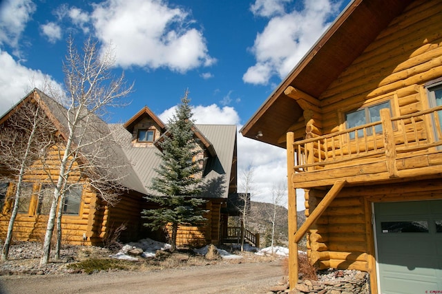 view of home's exterior with a balcony and a mountain view