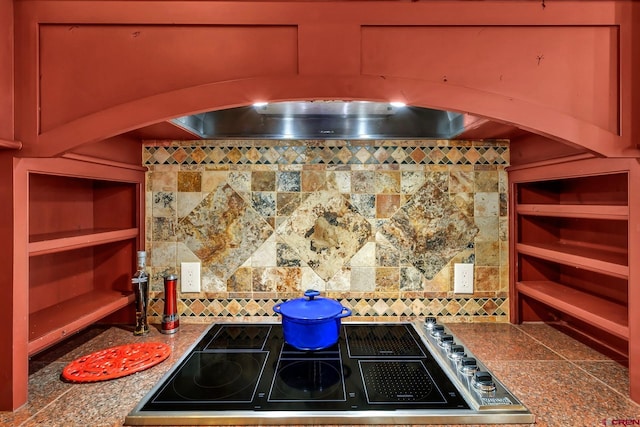 kitchen featuring stovetop and tasteful backsplash