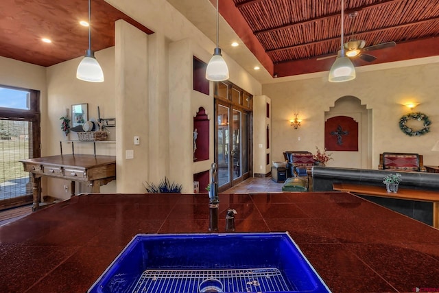 interior space with ceiling fan, sink, and pendant lighting