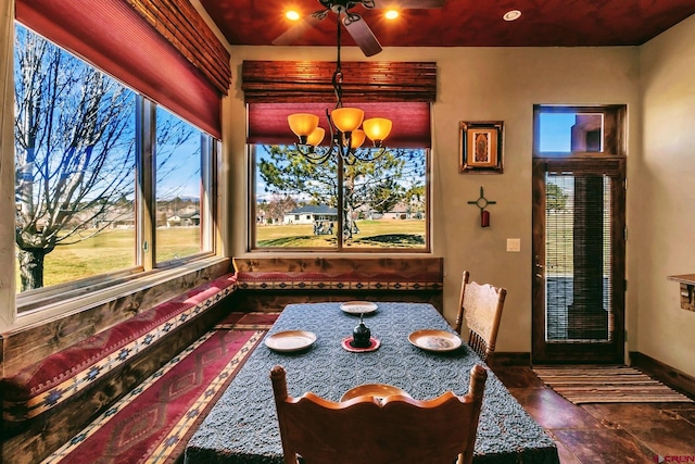 interior space with ceiling fan with notable chandelier