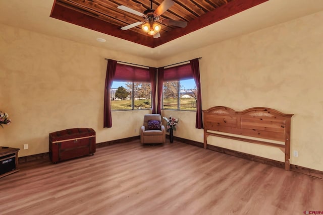 unfurnished room featuring ceiling fan, dark hardwood / wood-style floors, a tray ceiling, and wooden ceiling