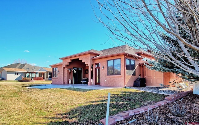 rear view of house with a patio and a lawn