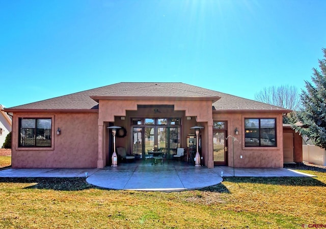 back of house with a patio area and a yard