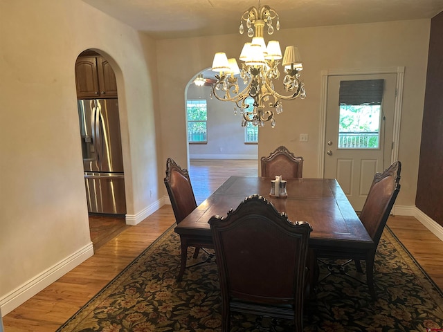 dining space featuring dark hardwood / wood-style floors and a notable chandelier