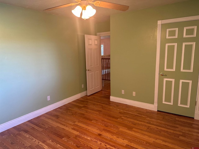 unfurnished bedroom featuring ceiling fan and dark wood-type flooring