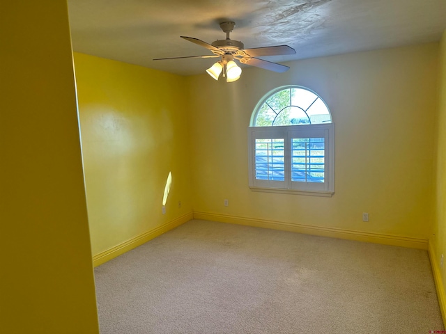 unfurnished room featuring light carpet and ceiling fan