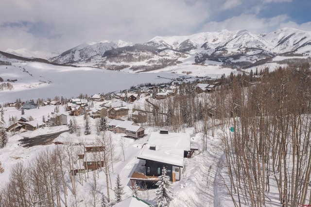 snowy aerial view with a mountain view