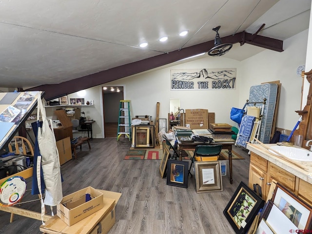 home office featuring sink, vaulted ceiling with beams, and hardwood / wood-style flooring