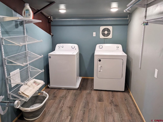 laundry area featuring washing machine and dryer and dark hardwood / wood-style floors