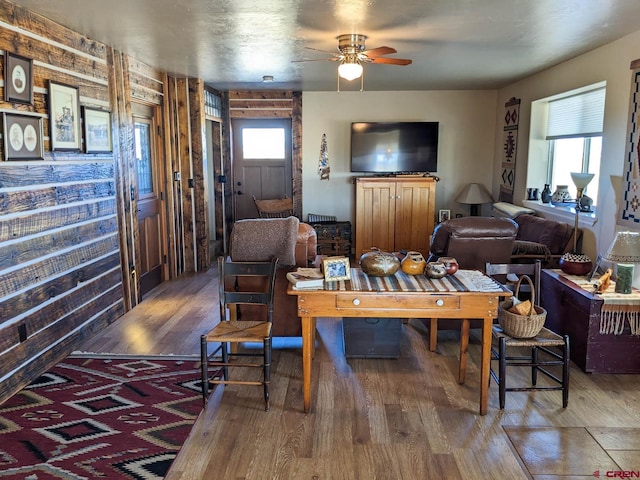 living room with dark hardwood / wood-style floors, ceiling fan, and a wealth of natural light