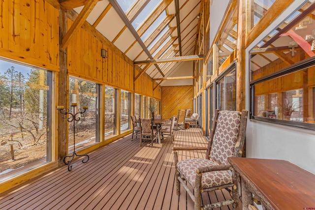 unfurnished sunroom featuring vaulted ceiling