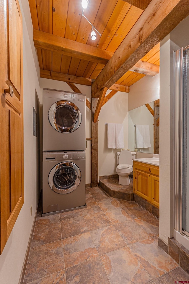 laundry room with tile floors, stacked washing maching and dryer, and wood ceiling