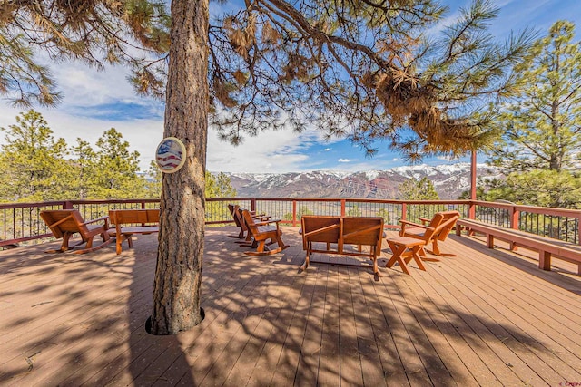 wooden deck with a mountain view