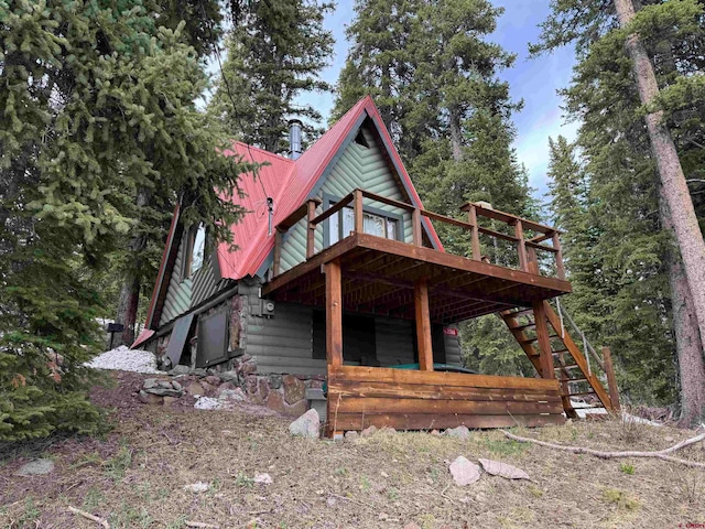 view of property exterior featuring a wooden deck