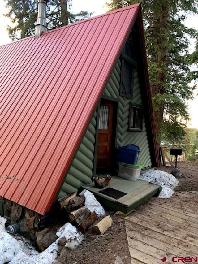 view of property exterior with a wooden deck