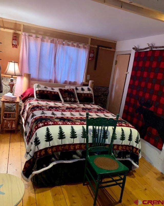 bedroom with wood-type flooring