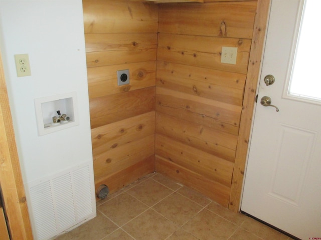 clothes washing area featuring hookup for an electric dryer, wood walls, light tile flooring, and hookup for a washing machine