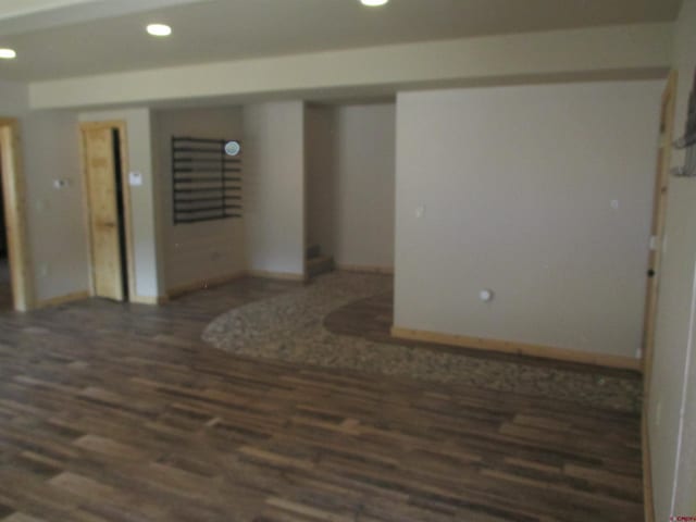 empty room with dark wood-type flooring