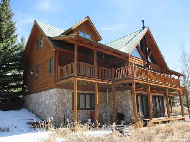 back of house featuring a balcony