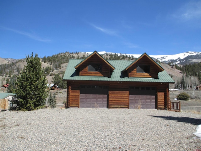 view of front facade featuring a mountain view and a garage