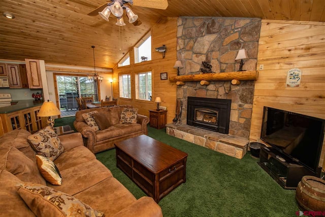 living room featuring wooden ceiling, wood walls, dark colored carpet, a fireplace, and ceiling fan with notable chandelier