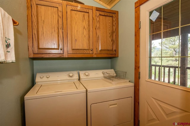 washroom with separate washer and dryer and cabinets