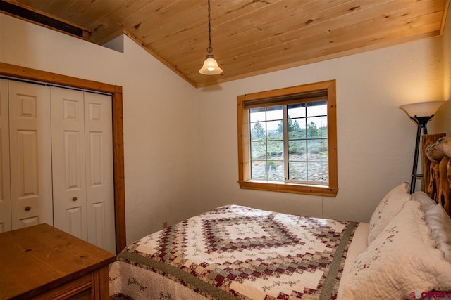 bedroom featuring a closet, wooden ceiling, and vaulted ceiling