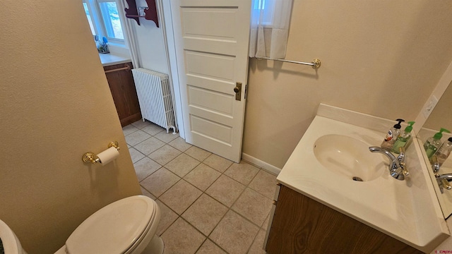 bathroom featuring tile patterned flooring, toilet, radiator heating unit, and vanity