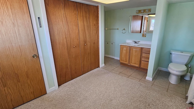 bathroom with tile patterned flooring, toilet, and vanity