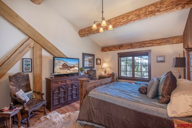 bedroom featuring lofted ceiling with beams and light hardwood / wood-style floors