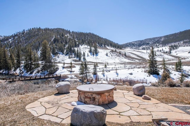 snow covered patio featuring a mountain view