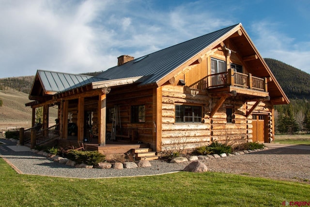 view of front of property with covered porch and a balcony