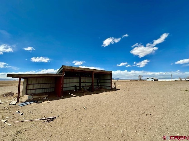 view of stable featuring a rural view